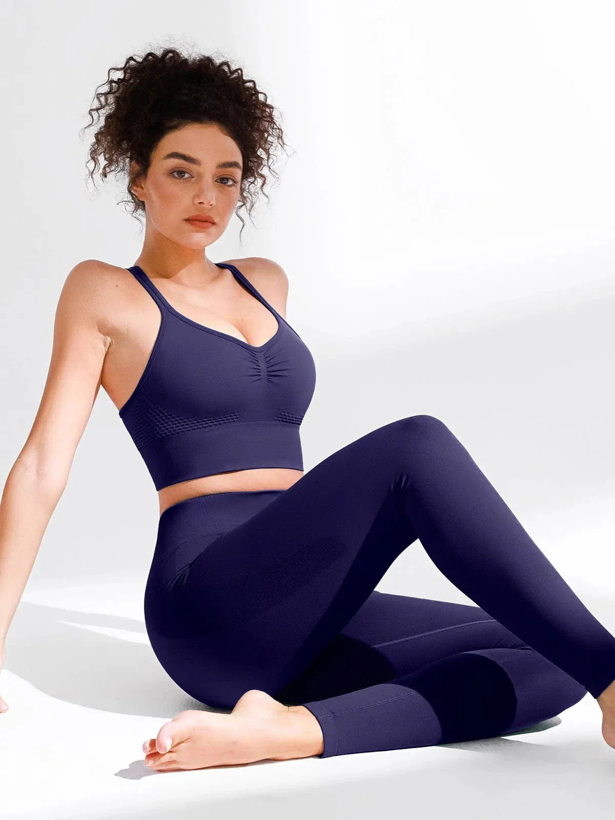 A model wearing a BRXL® Butt Lifting Seamless Bra Scrunch Leggings Set in